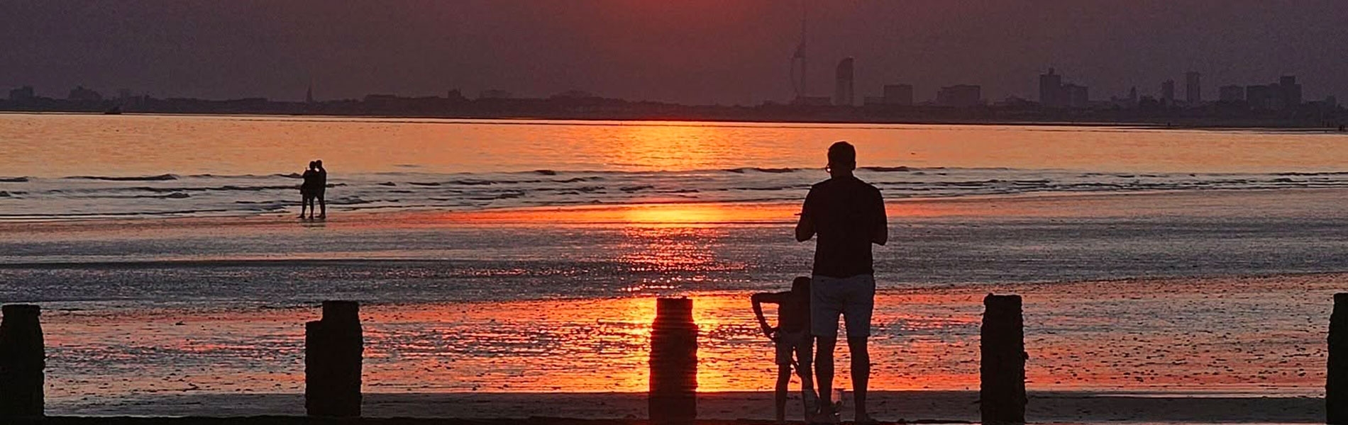 Sun setting with an orange sky over Bracklesham Bay beach