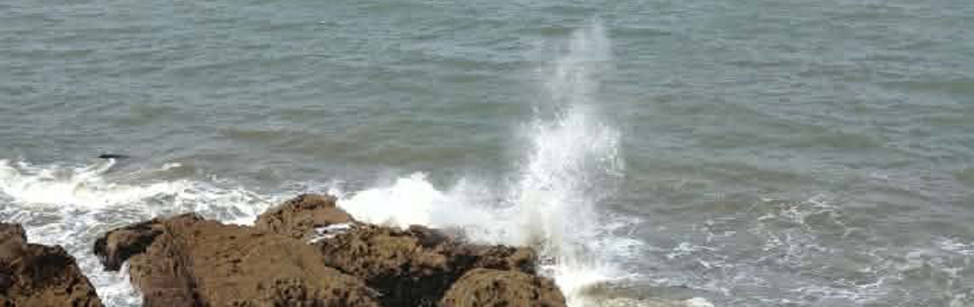 Waves crashing on rocks at Paignton beach