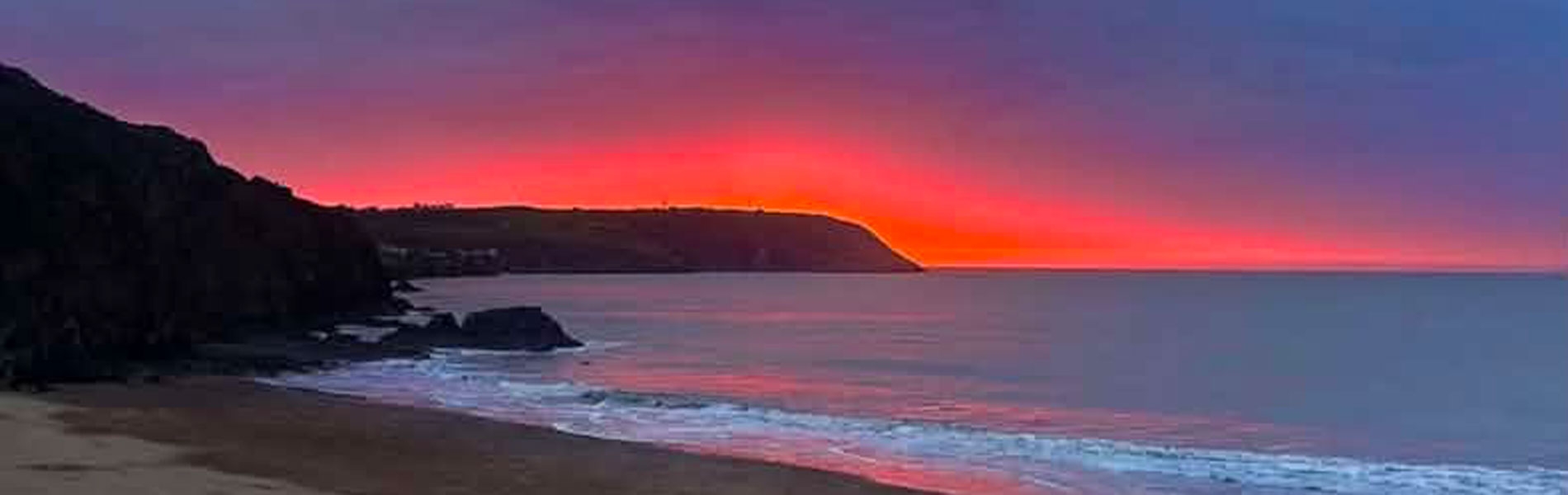 Purple and orange sunset at Tresaith beach