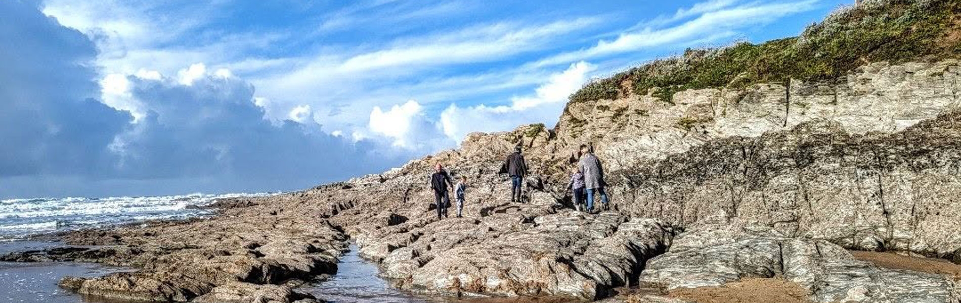 People on the rocks at Woolacombe beach